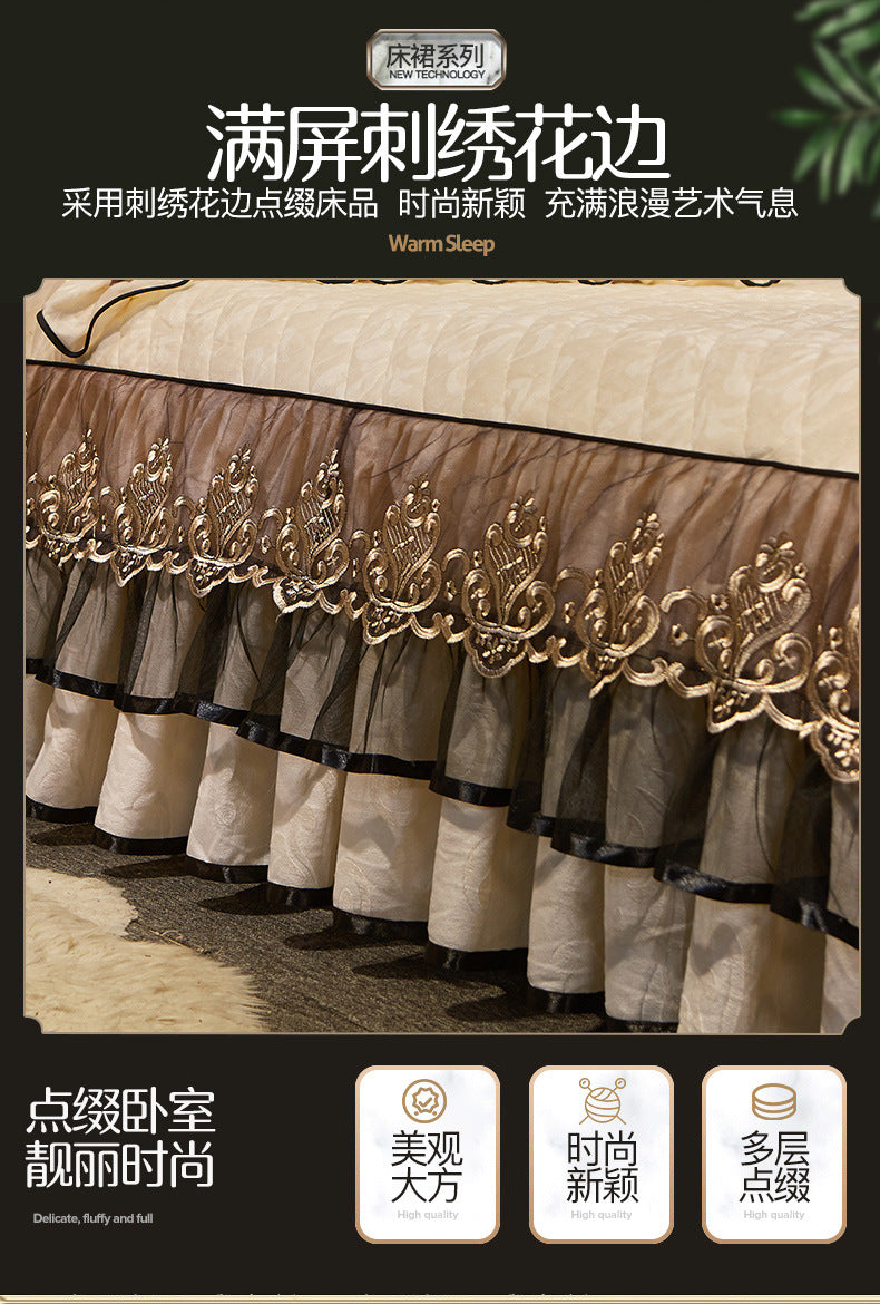 A set of three sheer beige bed skirts with ornate gold embroidery and black trim displayed on a bed.
