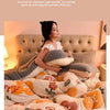 A cozy bed scene featuring a plush double-sided fleece blanket with velvet finish in warm, earthy tones.