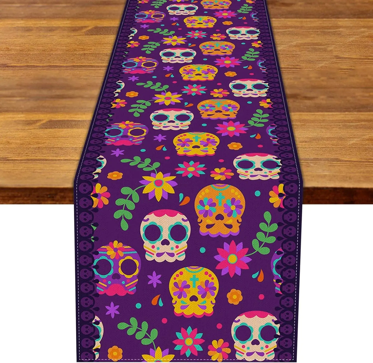 A purple linen table runner featuring a repeating pattern of colorful sugar skulls and floral designs.