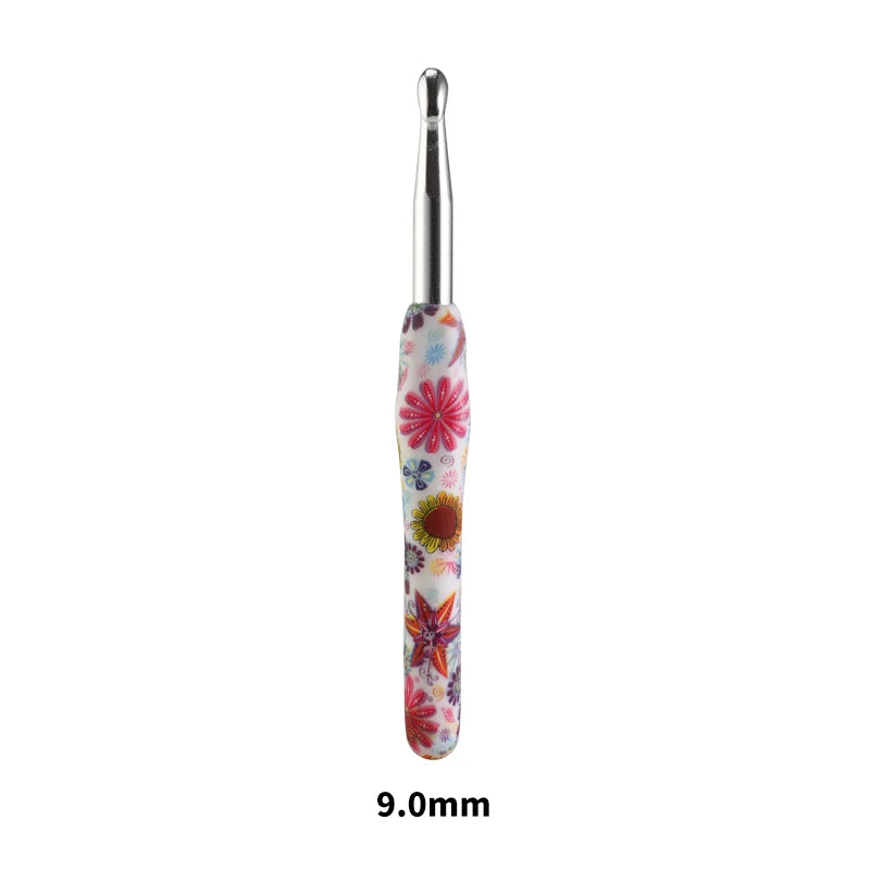 A silver crochet knitting hook with a colorful, floral-patterned handle.