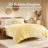 A bright yellow plush faux fur bubble blanket is displayed on a bed, adding texture to the room.