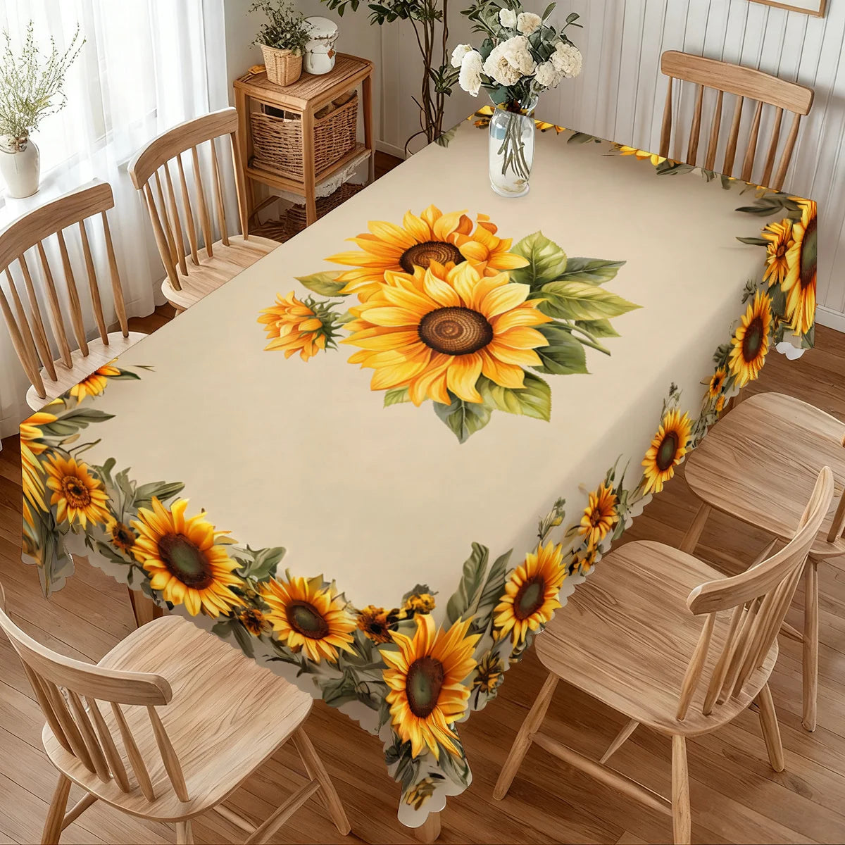 A long table covered with a sunflower floral waterproof tablecloth surrounded by wooden chairs.