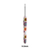 A long, slender handmade crochet knitting hook with a colorful floral design.