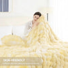 A fluffy yellow faux fur rabbit blanket is displayed on a bed, emphasizing its soft texture.