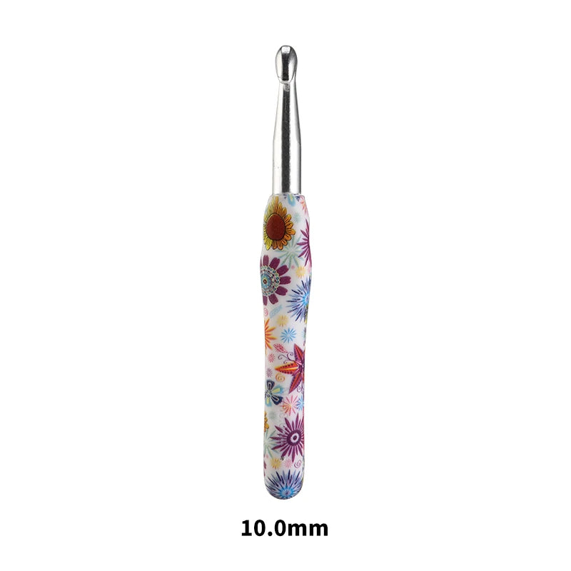 A silver crochet knitting hook with a colorful, floral-patterned handle.