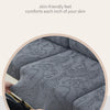 Close-up of a gray jacquard sofa cushion cover featuring an intricate, embossed pattern.