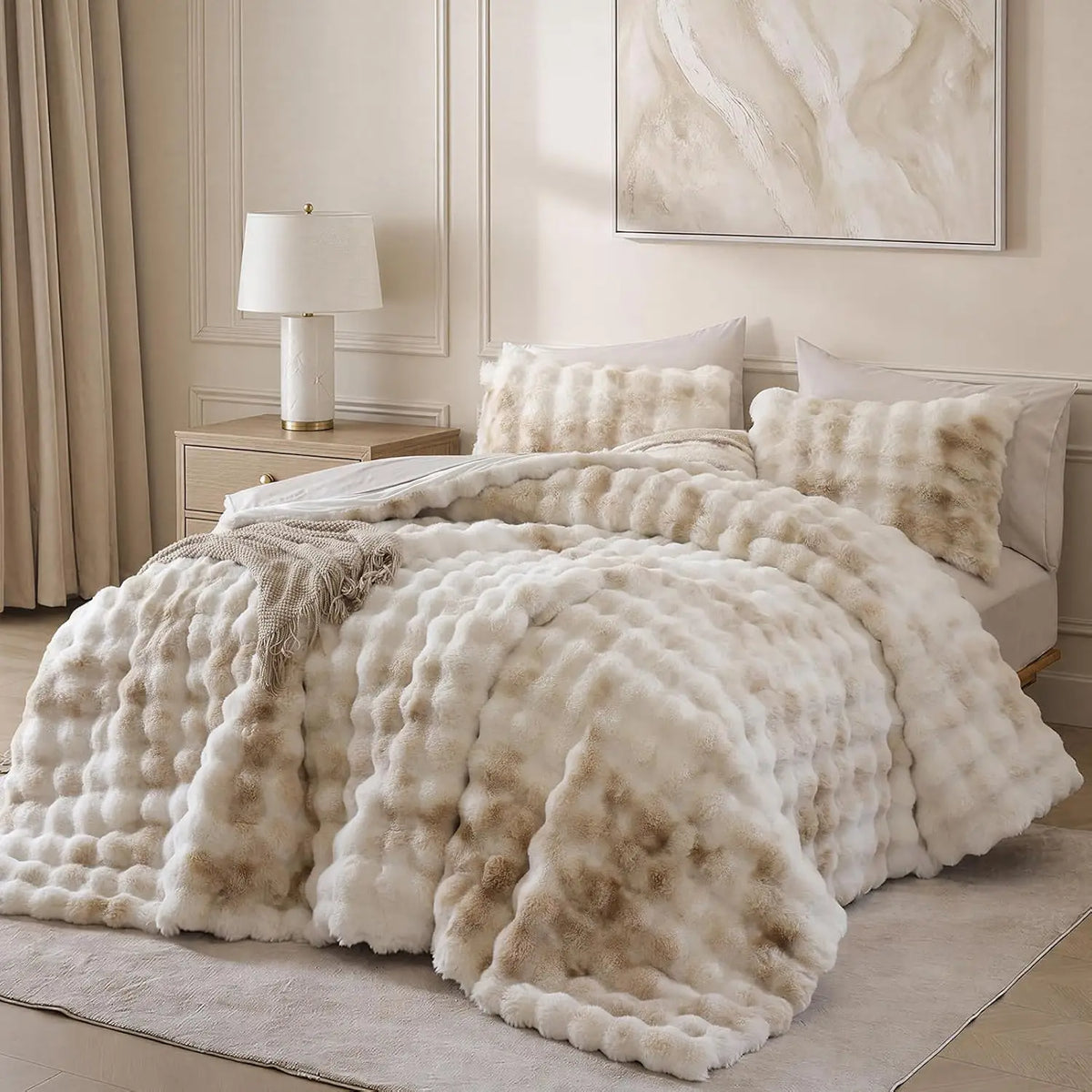 A large, fluffy cream faux fur blanket with a textured surface is displayed on a bed.