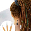 A close-up of a person's hair styled in dreadlocks with colorful threads, showing a set of crochet hooks.