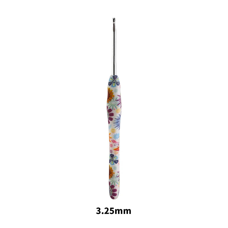 A long, slender crochet knitting hook with a colorful, floral design.