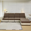 A modern sectional sofa with beige cushions and white trim sits on a light wood floor in a bright room.