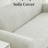 A close-up of a light gray elastic jacquard sofa cover featuring a textured, leaf-like pattern.