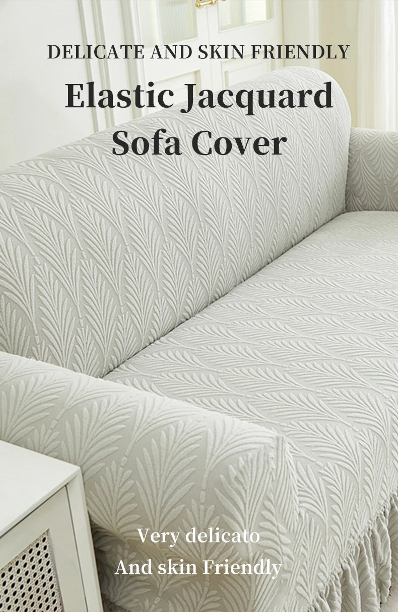 A close-up of a light gray elastic jacquard sofa cover featuring a textured, leaf-like pattern.