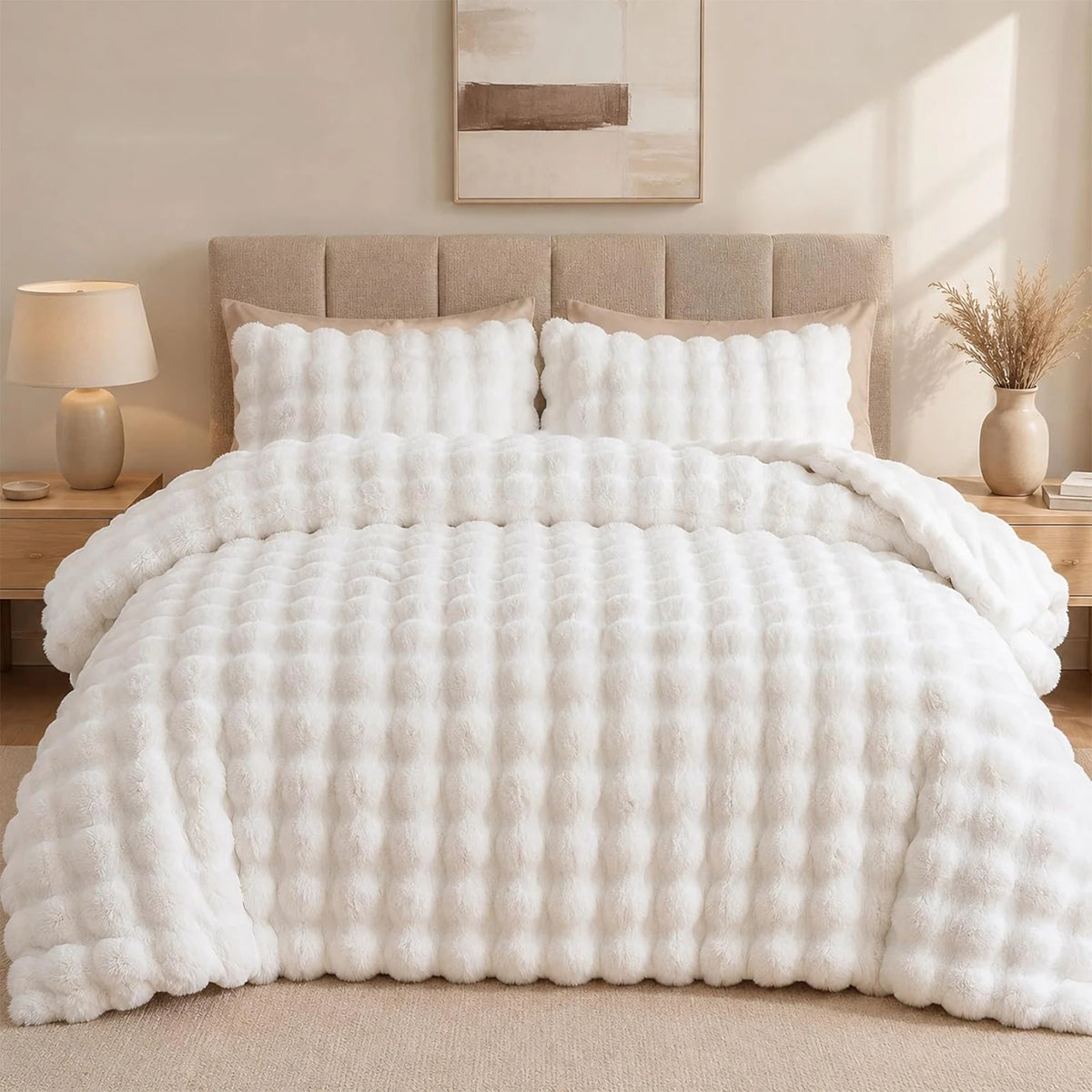 A fluffy white faux fur bubble blanket with a light beige velvet backing draped over a bed.