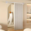 A white folding privacy curtain is installed on a silver rod in an arched doorway.
