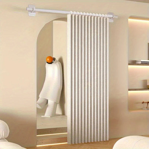 A white folding privacy curtain is installed on a silver rod in an arched doorway.