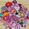 A collection of pink and purple embroidered cartoon iron-on patches featuring various shapes and designs.