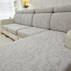 Light gray universal jacquard sofa cushion covers on a sectional sofa.