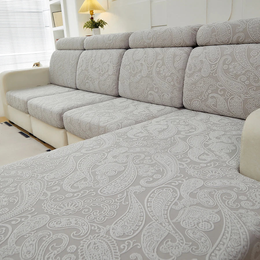 Light gray universal jacquard sofa cushion covers on a sectional sofa.