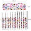 A set of handmade crochet knitting hooks in various sizes and colors displayed next to a measuring scale.