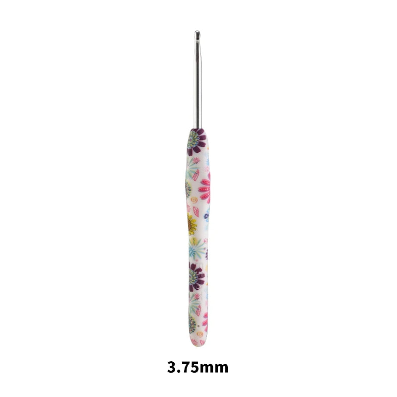 A long, slender crochet knitting hook with a colorful floral design.