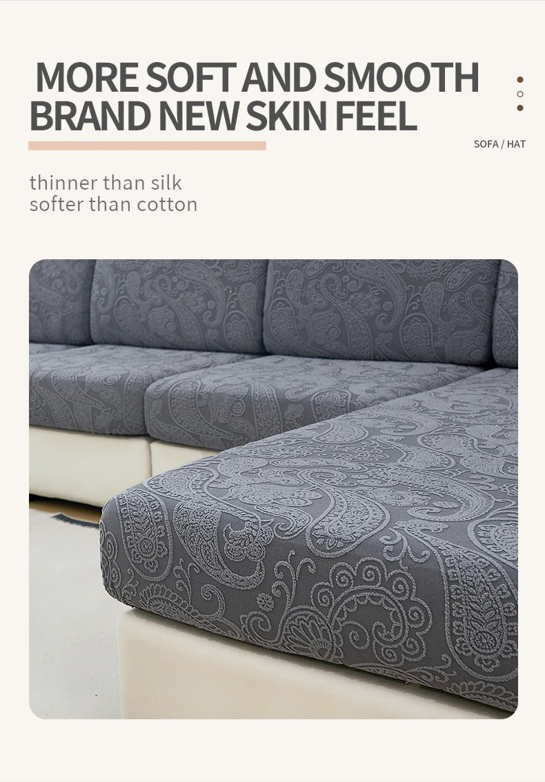 A close-up of a gray jacquard sofa cushion cover featuring an ornate pattern.