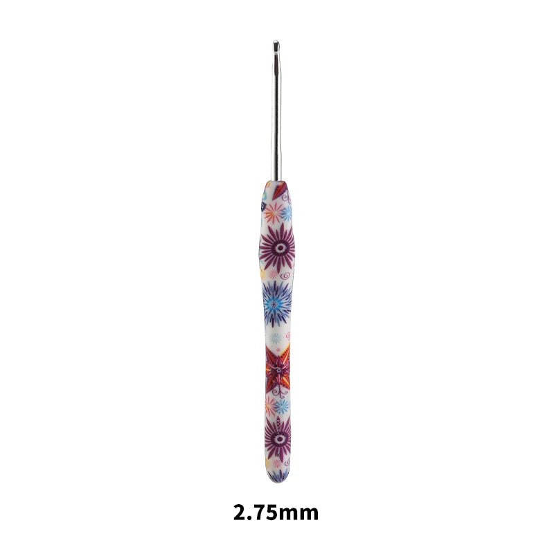 A close-up view of a handmade crochet knitting hook with colorful floral designs.