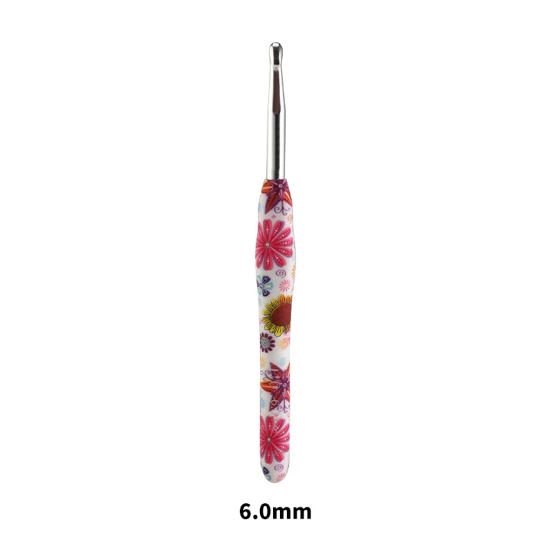 A handmade crochet knitting hook with a floral design, measuring 6.0mm.