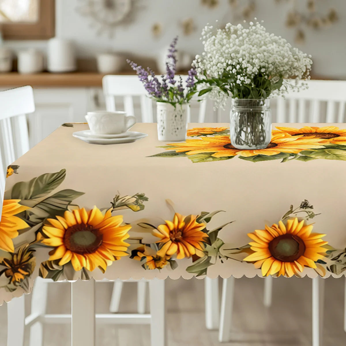 A light beige table is set with a sunflower floral waterproof tablecloth featuring yellow and green leaves.