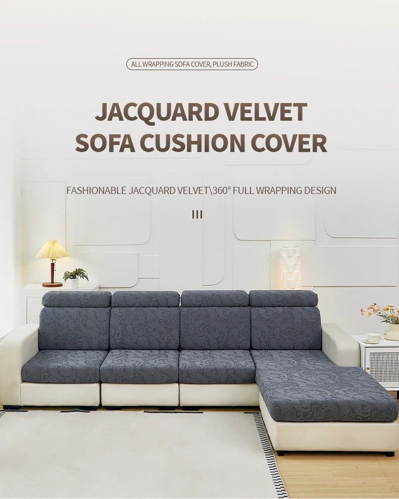A gray jacquard velvet sofa cushion cover displayed on a white sofa in a bright room.