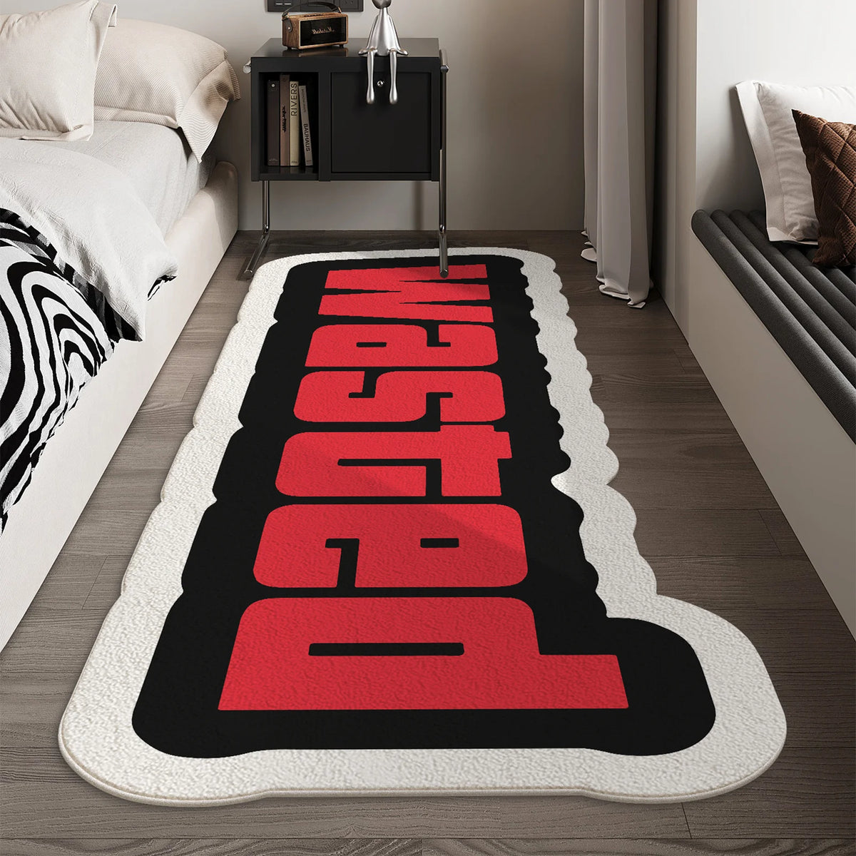 A black and red letter doormat with the word WASTED in large block letters placed on a wooden floor.