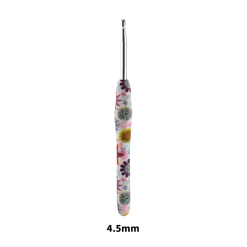 A long, slender crochet knitting hook with a colorful floral design.
