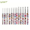 A collection of handmade crochet knitting hooks featuring colorful floral designs in various shades of pink, green, and white