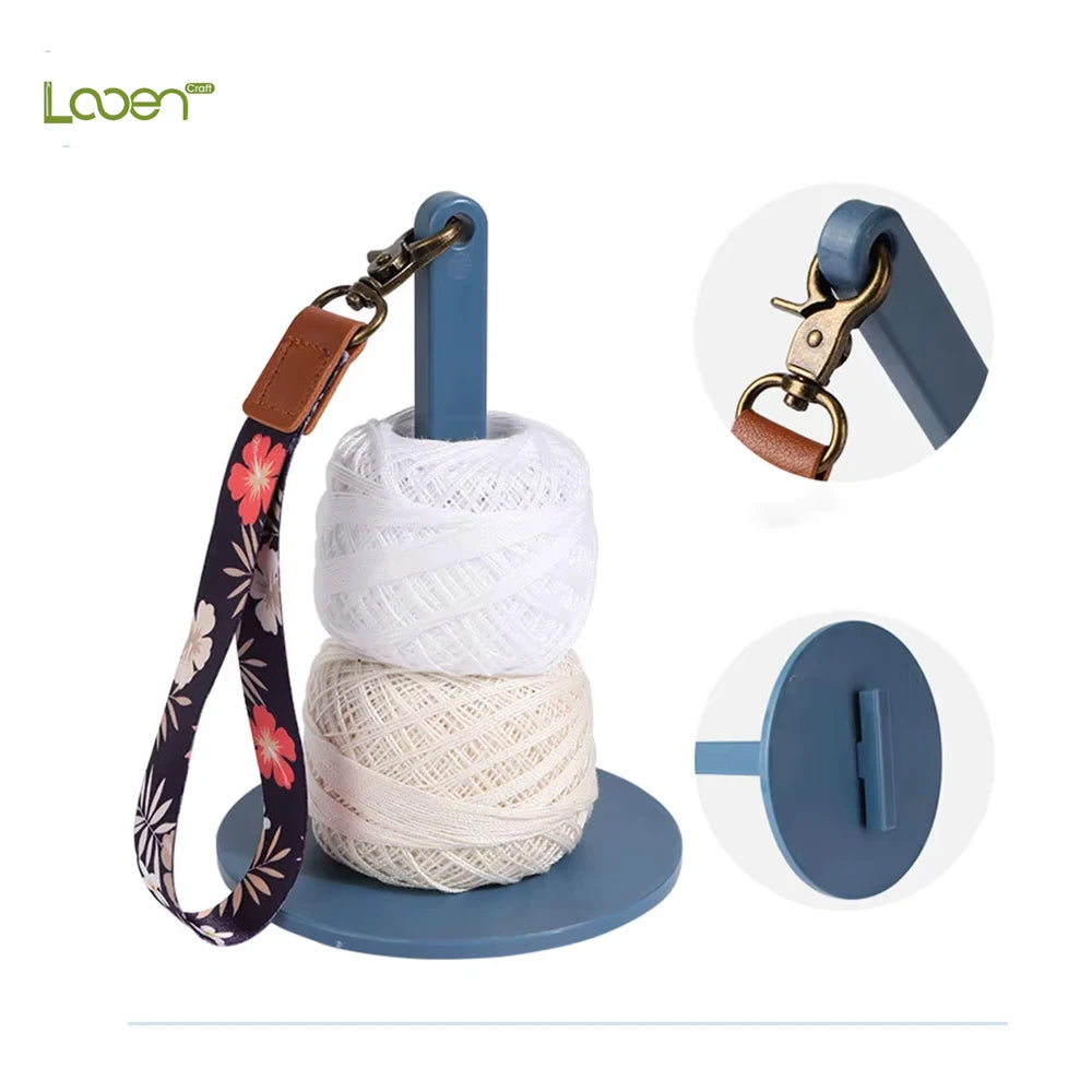 A set of adjustable yarn holders and winders featuring a leather strap and a blue plastic base.