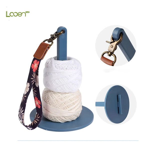A set of adjustable yarn holders and winders featuring a leather strap and a blue plastic base.