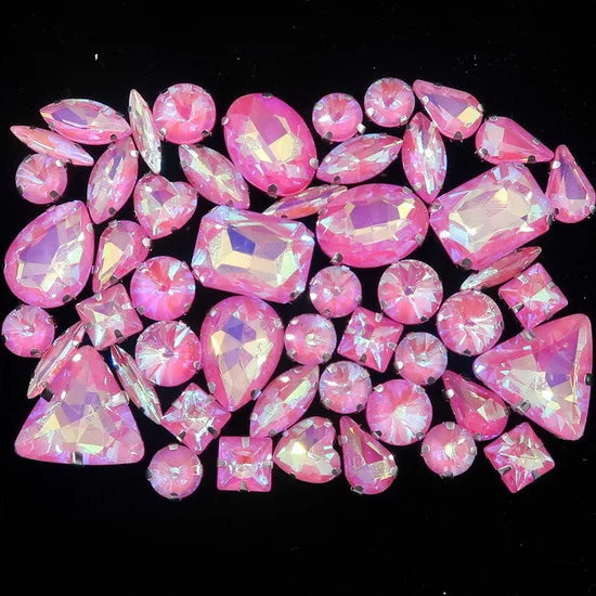 A collection of pink and magenta faceted rhinestones arranged in a decorative pattern.