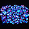 A close-up of a set of sparkling blue and purple rhinestones arranged on a dark background.