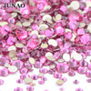 A pile of pink and clear glass rhinestones for DIY crafts