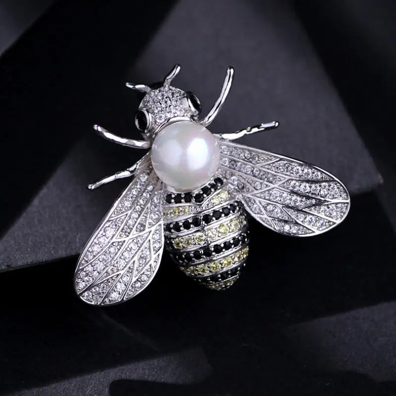 Silver crystal bee brooch featuring a pearl accent and detailed wings