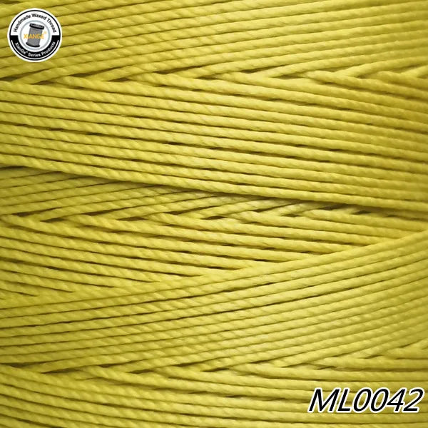 A spool of bright yellow waxed thread embroidery cord is shown in a close-up view.