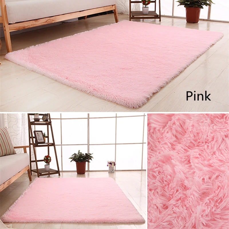A pink plush throw rug is displayed on a light wooden floor, showing its texture and softness.