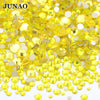 A pile of yellow and clear glass rhinestones for DIY crafts