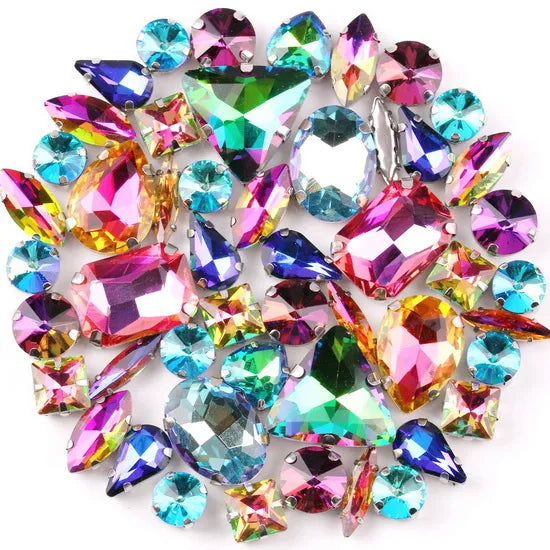 A collection of silver claw rhinestone decorations in various colors and cuts.