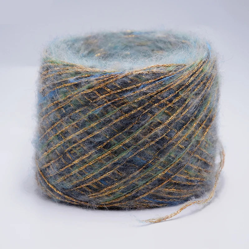 Spool of metallic gray and blue merino wool yarn for hand knitting