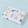 A white cotton muslin swaddle blanket featuring various blue and yellow animal designs.