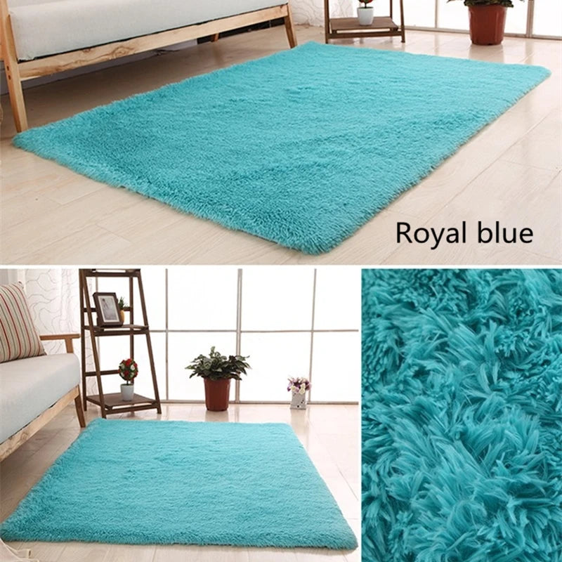 A plush royal blue throw rug displayed on a light wooden floor.