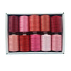 A box containing ten spools of polyester sewing thread in various shades of pink and red.