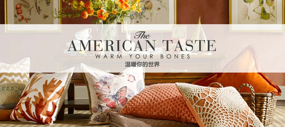 A collection of decorative pillows and framed art featuring warm earth tones and floral patterns.