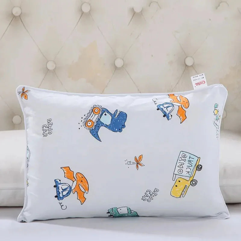 A white cartoon style children's pillowcase featuring colorful vehicles and animals.