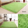 A bright green plush throw rug placed on a light wooden floor next to a sofa.