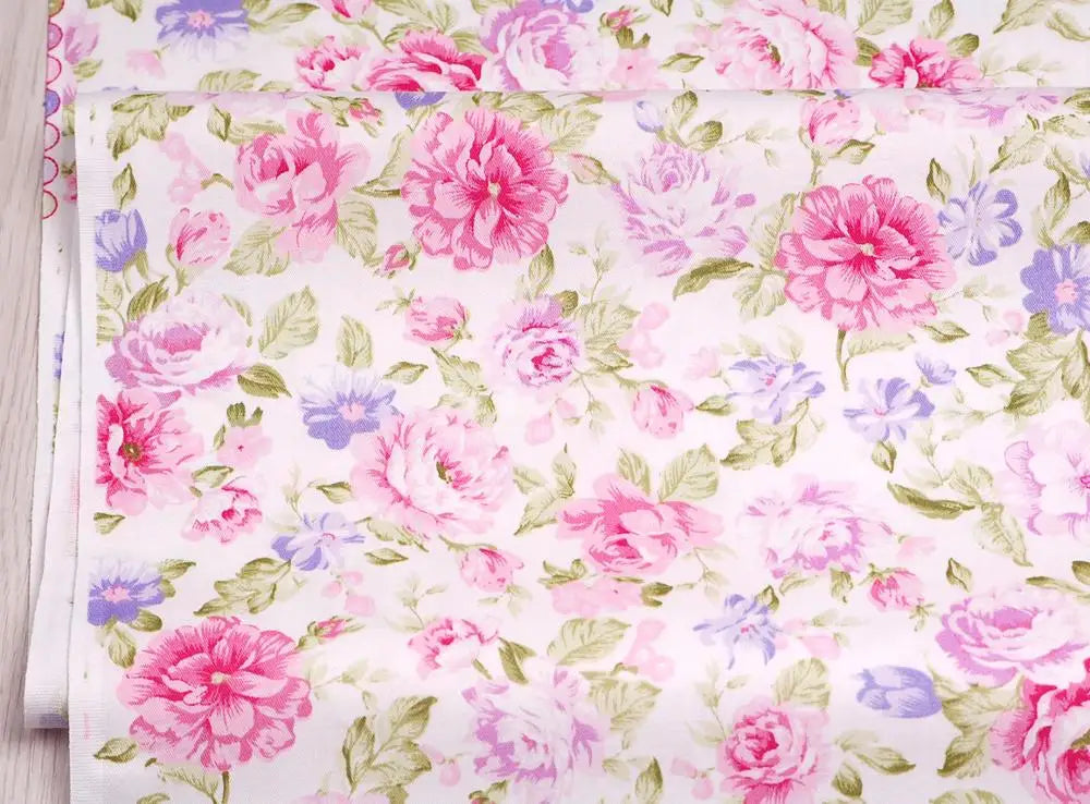 Pink floral and stripe cotton twill fabric featuring pink, purple, and green roses and foliage.